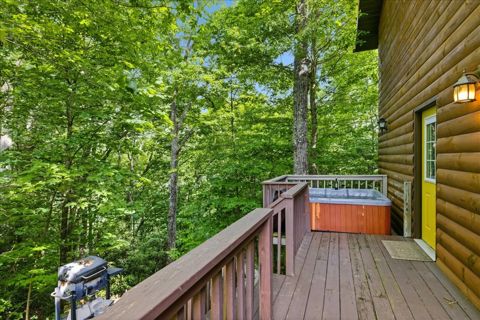 Side deck with the private hot tub and grill