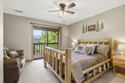 Queen room with a loveseat and balcony door
