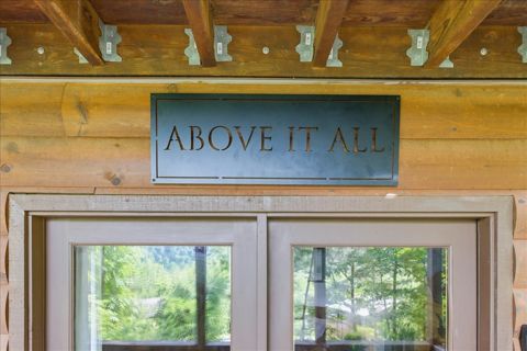 The Above It All sign over the glass doors